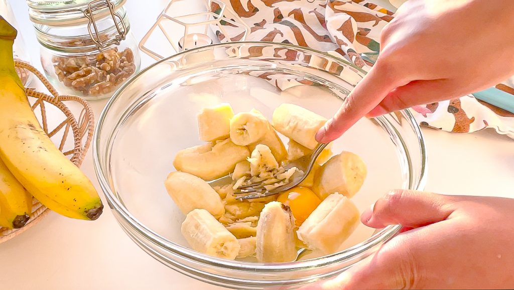 step one mashing banana and egg in a glass bowl