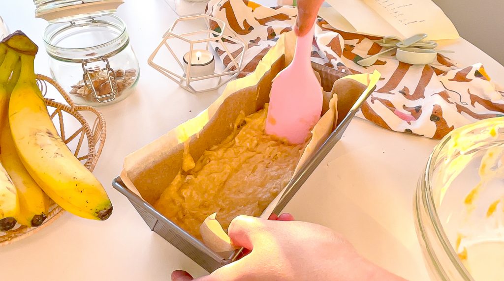 banana bread batter in the loaf tin spread evenly