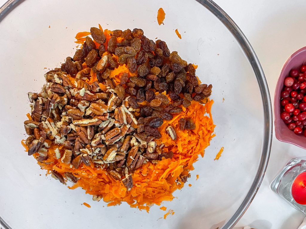 carrot cake wet ingredients with shredded carrots raisins and pecan